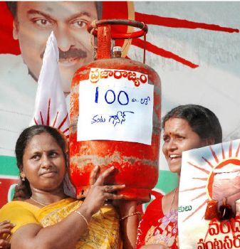 Activists of the Praja Rajyam campaign for their party which promises LPG cylinders and monthly groceries at Rs.100, at Sikhamani centre in Vijayawada on Tuesday.
